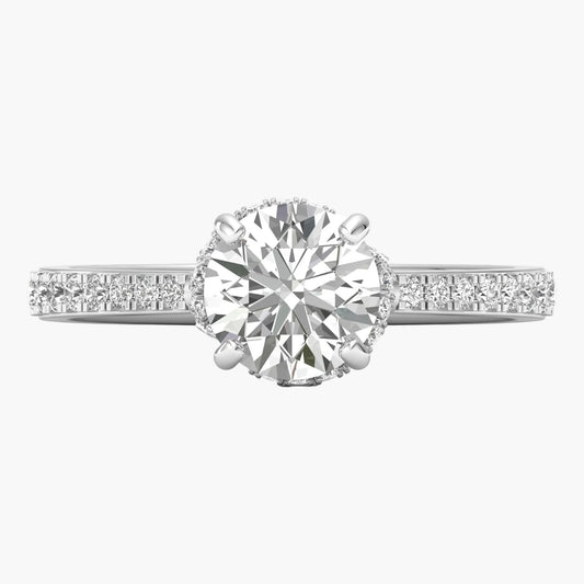 Diamond ring with a large central gemstone and smaller stones on the band against a white background