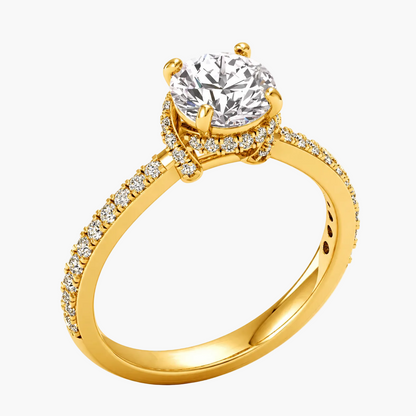Gold ring with a large diamond and smaller diamonds on the band against a white background