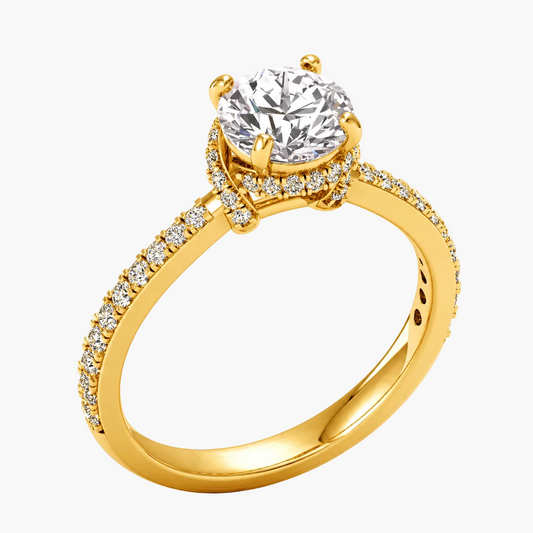Gold ring with a large diamond and smaller diamonds on the band against a white background