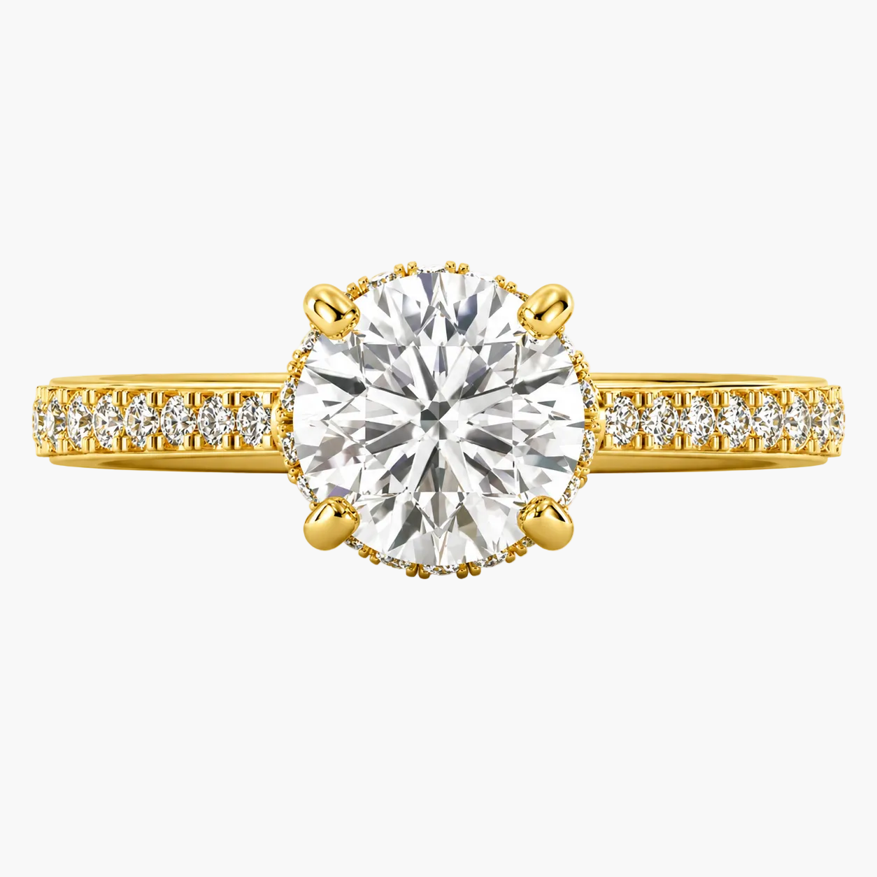 Gold ring with a large diamond and smaller diamonds on the band against a white background