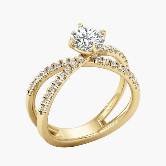 A yellow gold solitaire engagement ring with a round brilliant-cut diamond center stone and pavé-set accent diamonds along a twisted split-shank band, shown on a light gray background.