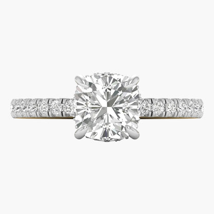 Diamond ring with a large central gemstone and smaller stones on the band against a white background
