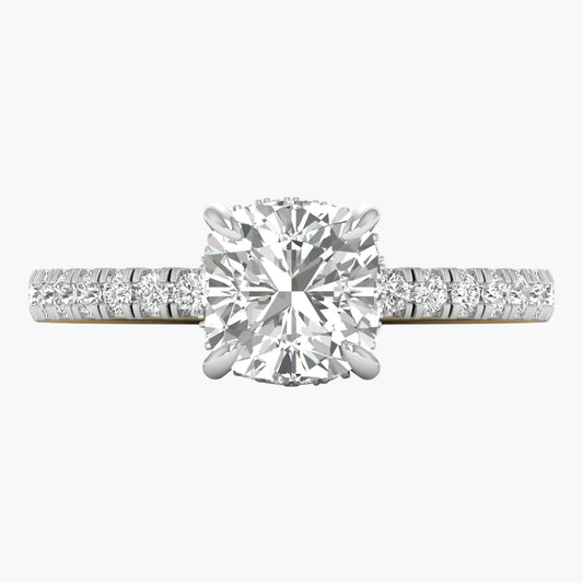 Diamond ring with a large central gemstone and smaller stones on the band against a white background