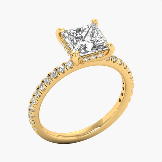 Gold ring with a large diamond and smaller diamonds on the band against a white background