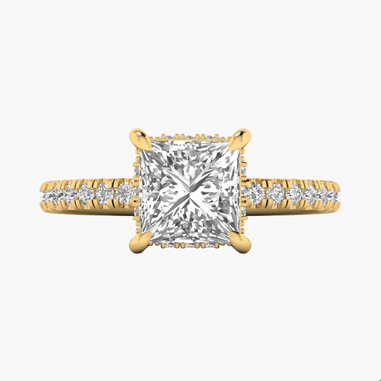 Gold ring with a large diamond and smaller diamonds on the band against a white background