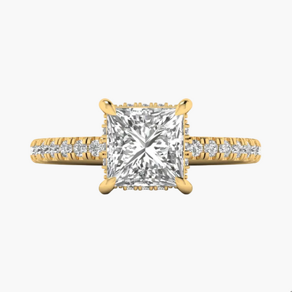 Gold ring with a large diamond and smaller diamonds on the band against a white background