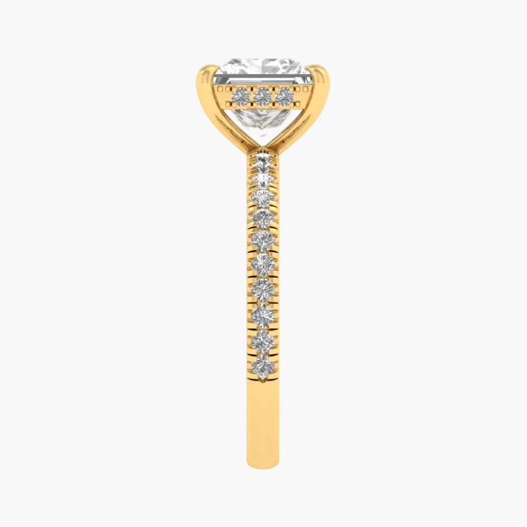Gold ring with a diamond-shaped center and smaller diamonds on a white background