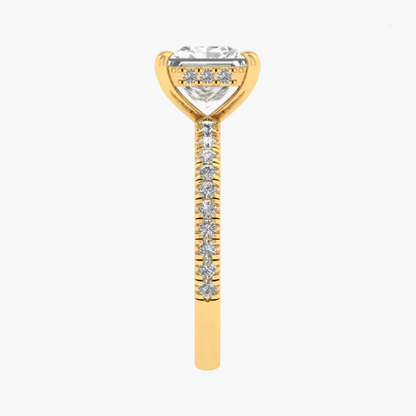 Gold ring with a diamond-shaped center and smaller diamonds on a white background
