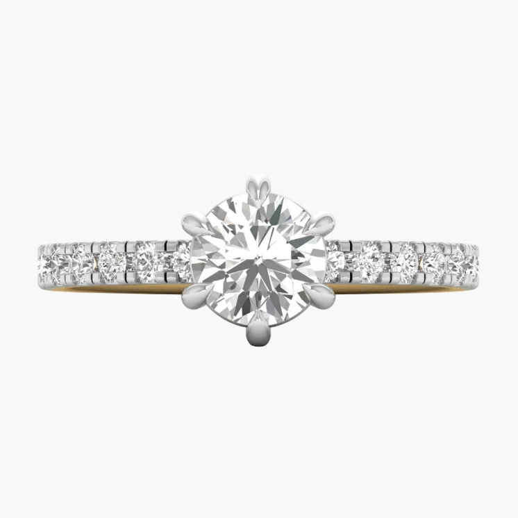 Diamond ring with a yellow gold band on a white background