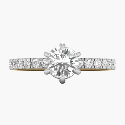 Diamond ring with a yellow gold band on a white background