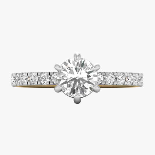 Diamond ring with a yellow gold band on a white background