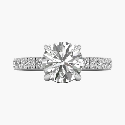 Diamond ring with a large central gemstone and smaller stones on the band against a white background