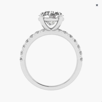 Silver ring with a large central diamond and smaller diamonds on the band against a white background