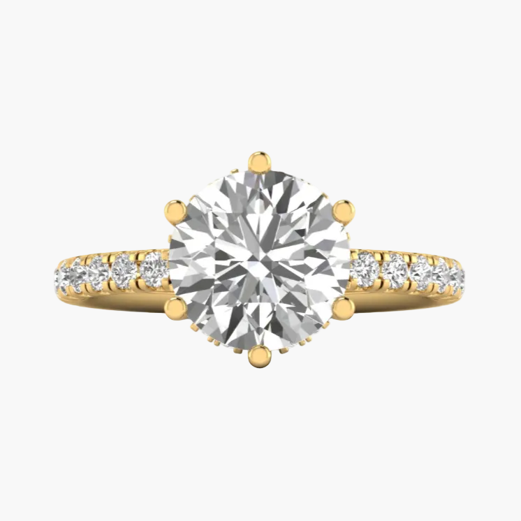 Gold ring with a large diamond and smaller diamonds on the band against a white background