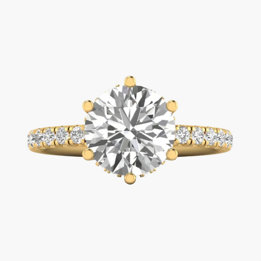 Gold ring with a large diamond and smaller diamonds on the band against a white background