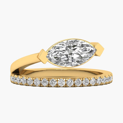 Gold ring with a marquise-shaped diamond and smaller diamonds on the band against a white background