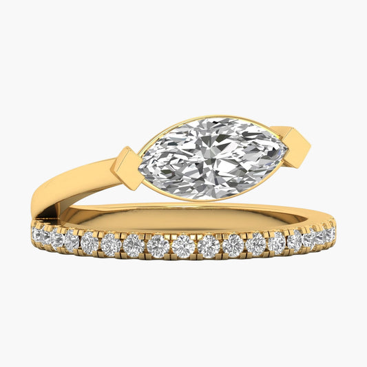 Gold ring with a marquise-shaped diamond and smaller diamonds on the band against a white background