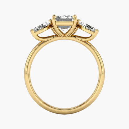 Gold ring with a central diamond and two smaller diamonds on a white background