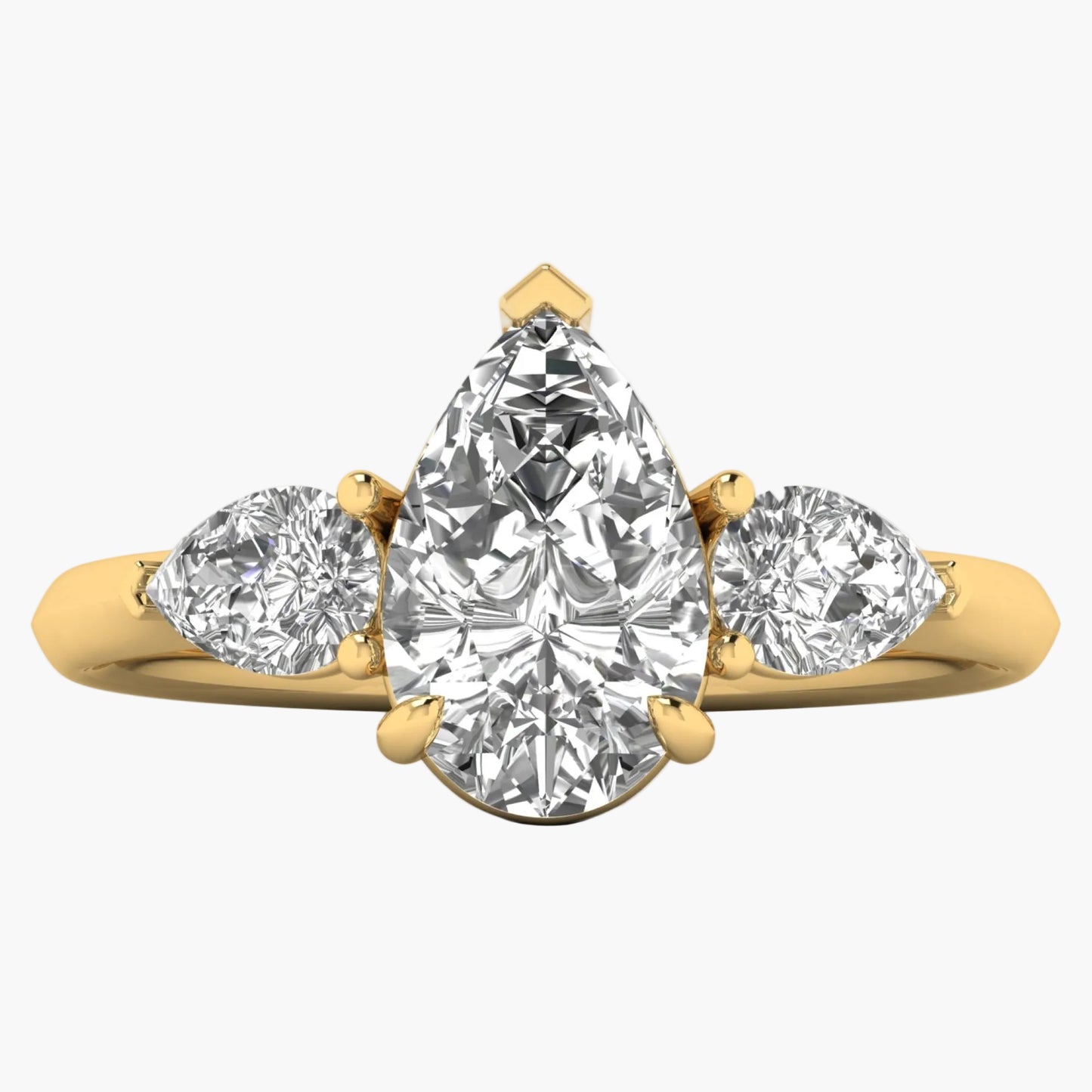 Gold ring with three pear-shaped diamonds on a white background
