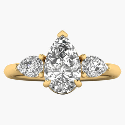Gold ring with three pear-shaped diamonds on a white background