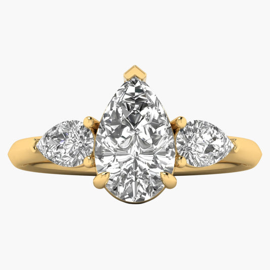 Gold ring with three pear-shaped diamonds on a white background