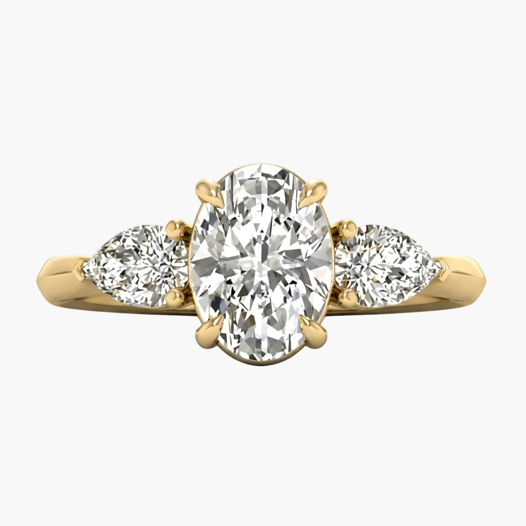 Gold ring with a central oval diamond and two pear-shaped diamonds on a white background