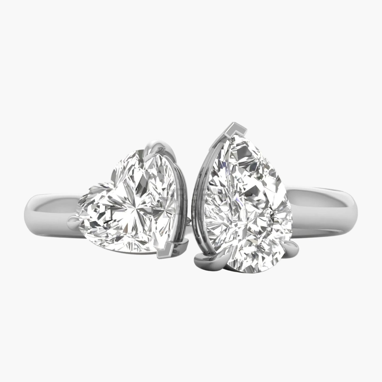 Two diamond rings, one heart-shaped and one pear-shaped, on a white background.