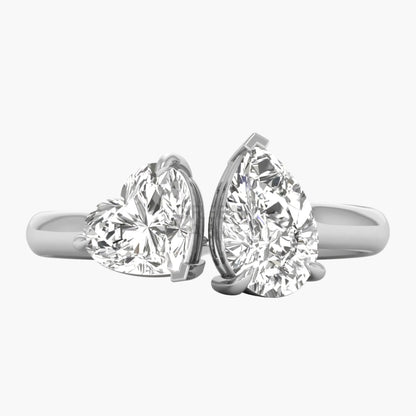 Two diamond rings, one heart-shaped and one pear-shaped, on a white background.