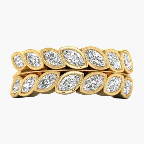 Gold ring with marquise-shaped diamonds on a white background