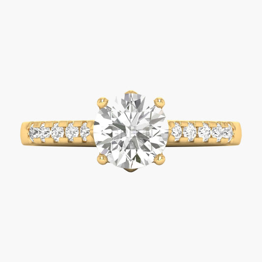 Gold ring with a large diamond and smaller diamonds on the band against a white background