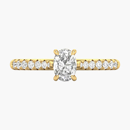 Gold ring with a large diamond and smaller diamonds on the band against a white background