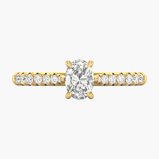 Gold ring with a large diamond and smaller diamonds on the band against a white background