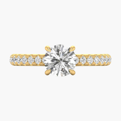 Gold ring with a large diamond and smaller diamonds on the band against a white background