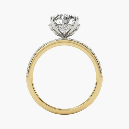 A yellow gold ring with a white gold or platinum solitaire setting and pavé accents, shown on a clean white background.