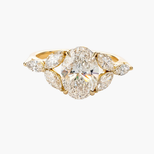 Gold ring with a large central diamond and smaller diamonds on a white background