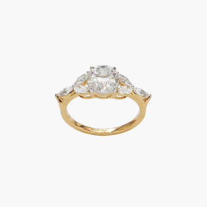 Gold ring with a central diamond and smaller diamonds on a white background