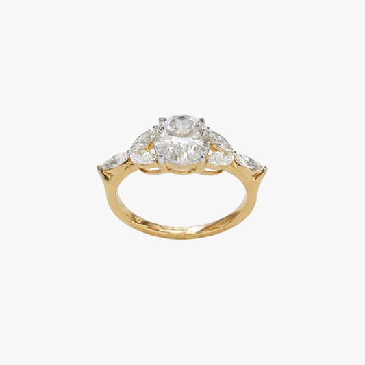 Gold ring with a central diamond and smaller diamonds on a white background