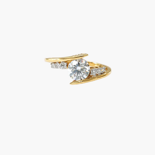 Gold ring with a large diamond and smaller diamonds on a white background