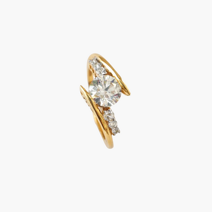 Gold ring with a large diamond and smaller diamonds on a white background