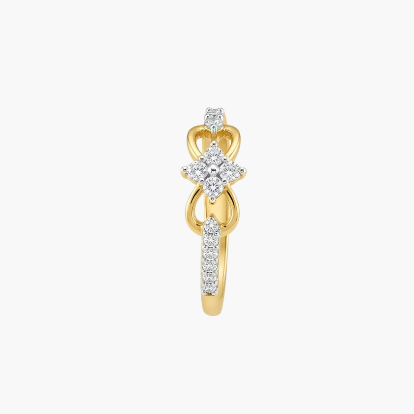 A yellow gold huggie ring featuring a central diamond cluster and pavé-set diamonds along the band, shown on a light gray background.