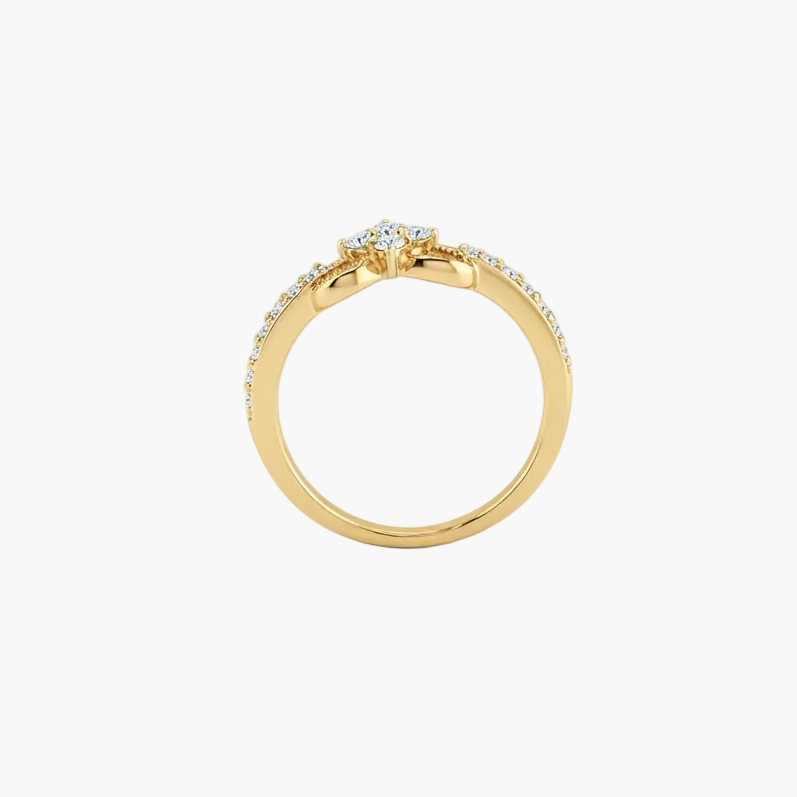 A yellow gold ring with a central round-cut diamond and a pavé band of small clear stones, shown on a clean white background.