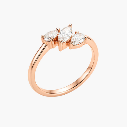 A rose gold ring featuring three marquise-cut clear gemstones in a row, set on a polished band, shown against a plain white background.