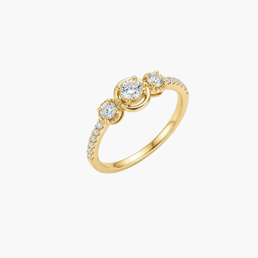 Gold ring with a clear gemstone on a white background