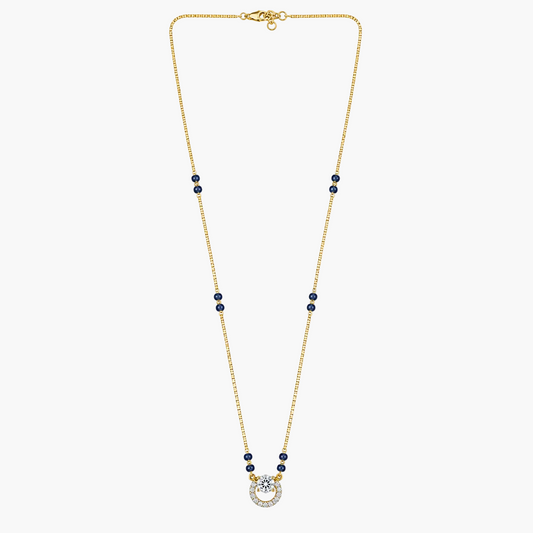 A delicate gold chain necklace featuring small dark blue bead accents spaced along the chain and a horseshoe pendant set with clear stones, displayed on a solid white background.