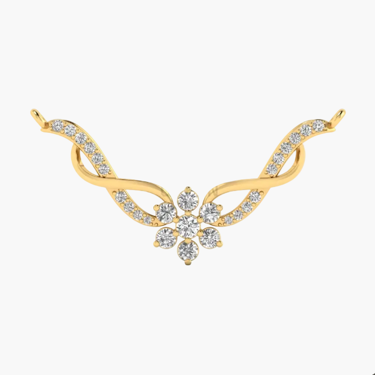 A gold-toned jewelry piece featuring a central floral cluster of clear stones set on a curved, wing-like design with additional small clear stones along the sides, shown on a plain white background.