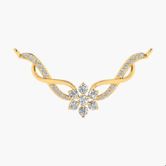 A gold-toned jewelry piece featuring a central floral cluster of clear stones set on a curved, wing-like design with additional small clear stones along the sides, shown on a plain white background.