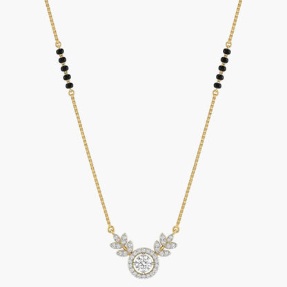 Gold necklace with a round pendant and black beads on a white background