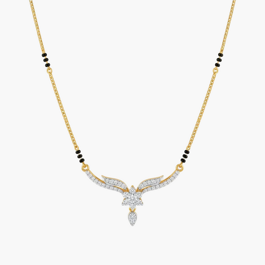 A gold chain necklace featuring a central winged pendant paved with clear stones, accented by small black bead clusters on the chain, shown on a light gray background.
