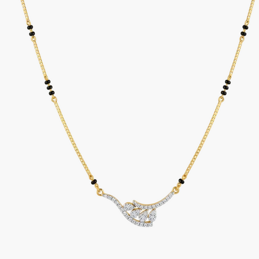 A gold chain necklace featuring a central pendant paved with clear stones in a curved, openwork design, accented by small black beads spaced along the chain, set against a light gray background.