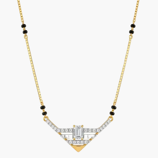 A gold chain necklace with a geometric Art Deco style pendant, featuring clear baguette and round-cut stones, accented with small black beads on the chain, shown against a plain white background.